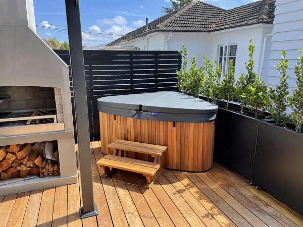 Spa pool on deck with wood fireplace